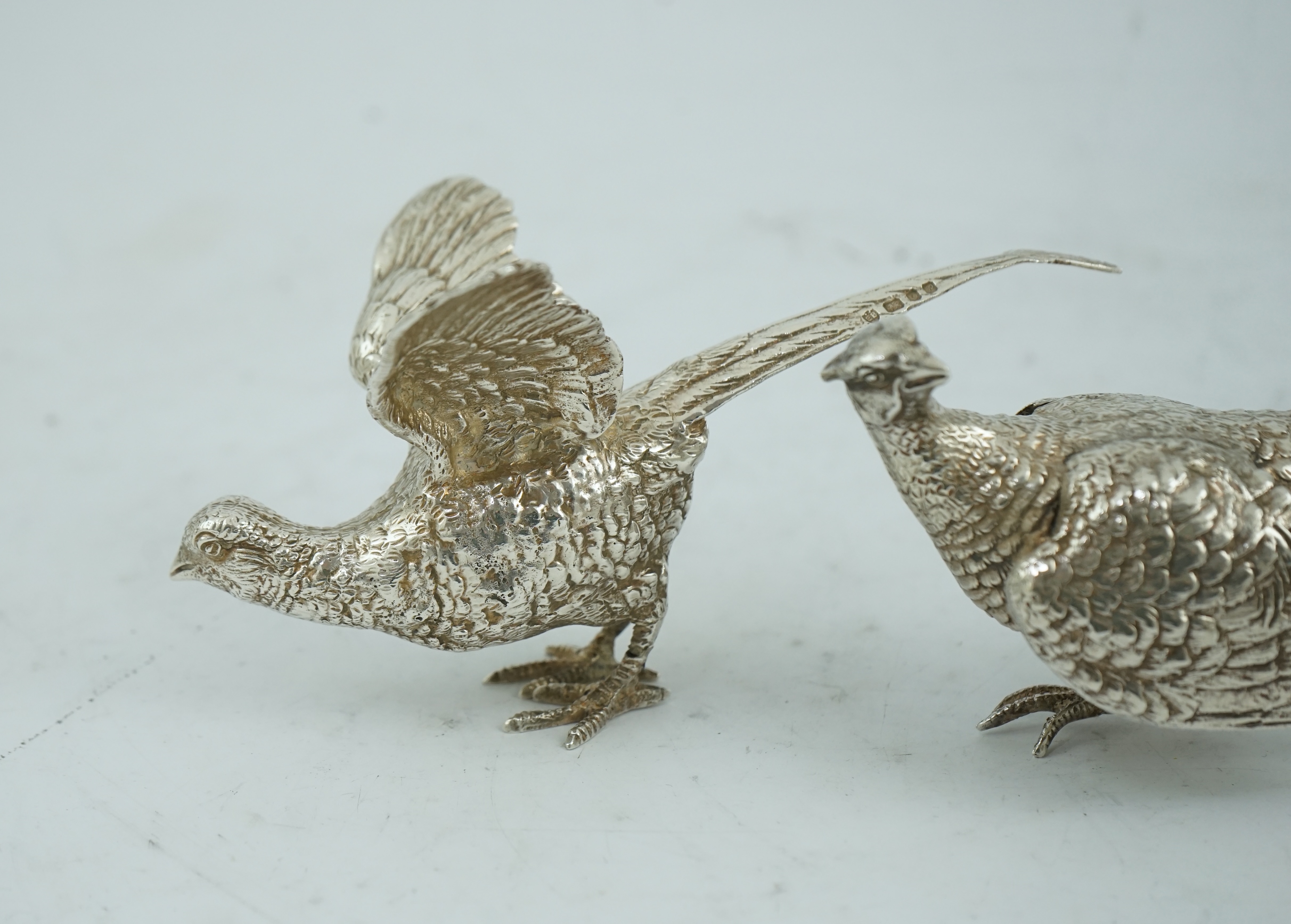 A pair of Elizabeth II silver free-standing model pheasants, by Edward Barnard & Sons Ltd